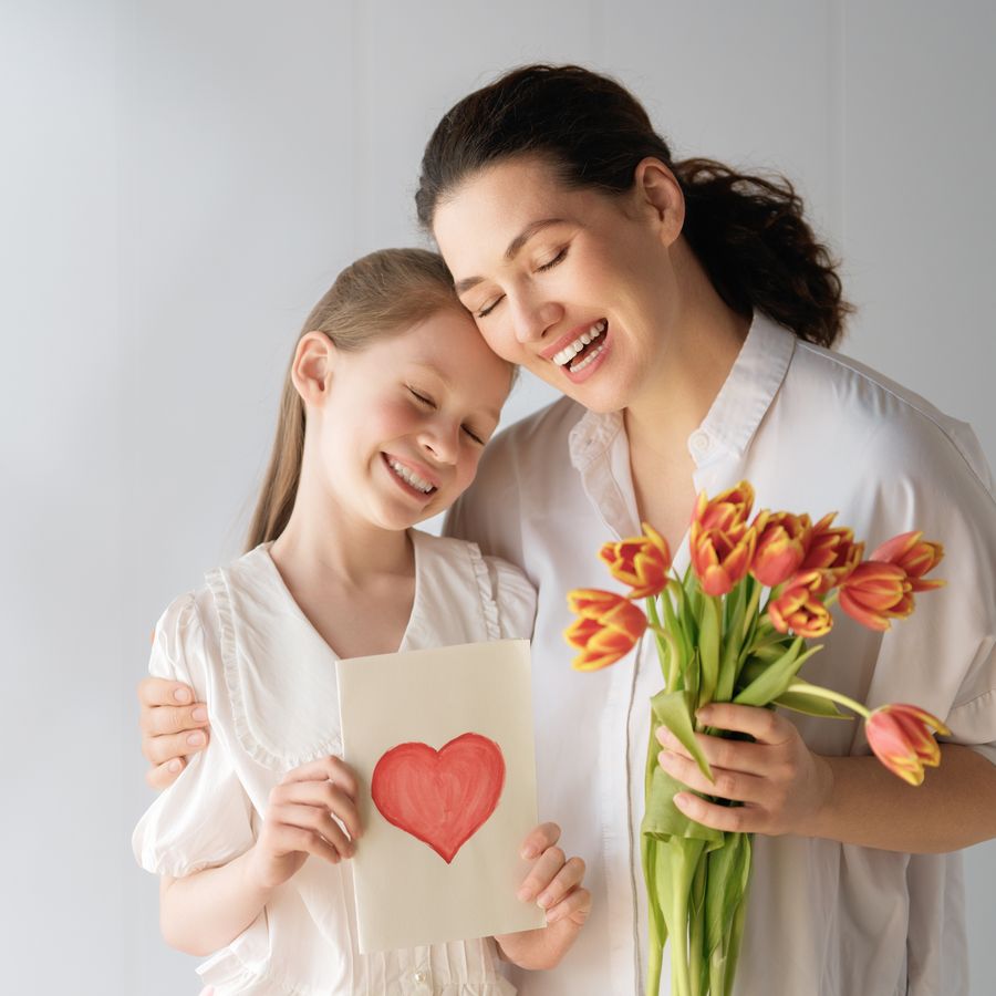 Girl giving her mother tulips and a card